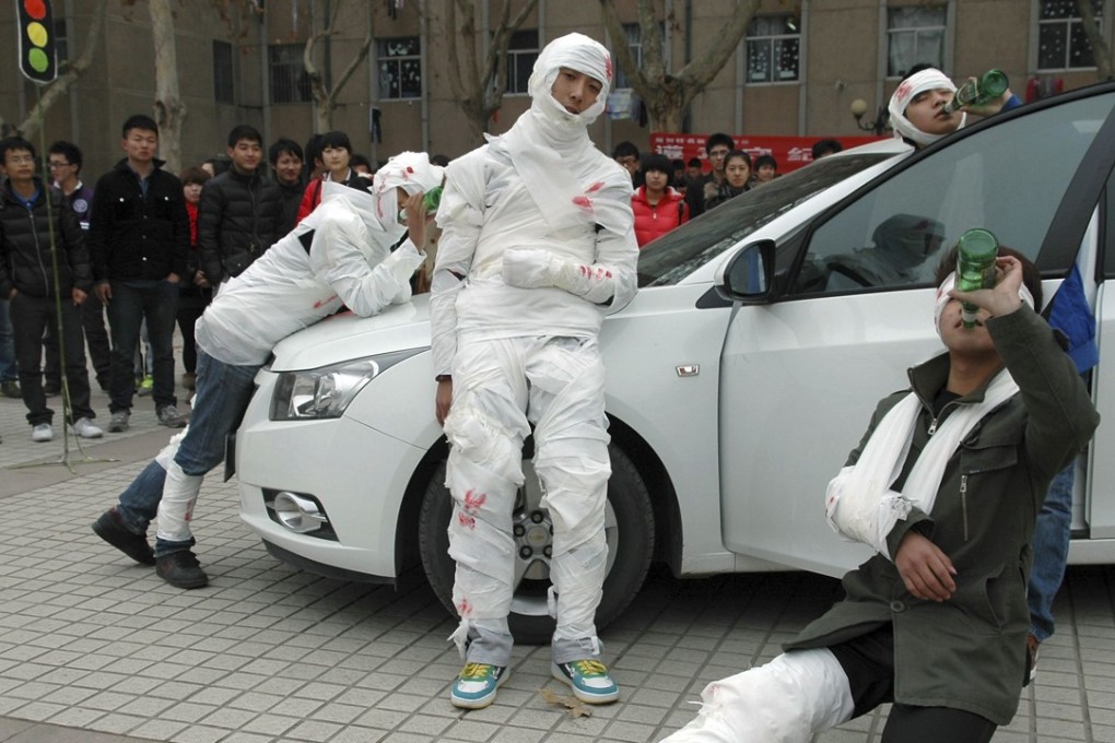 Students wearing bandages act as drunk drivers and passengers during an action art performance in Liaocheng, Shandong province. When the Chinese government cracked down on drink driving in 2011, the country’s spirits industry took a hit. Photo: Reuters