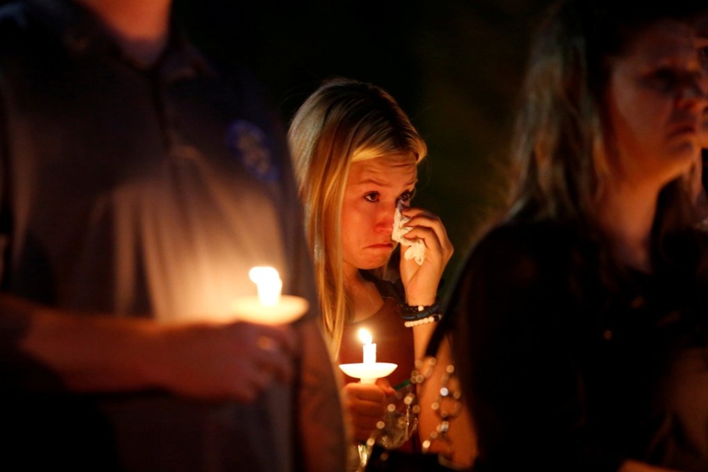 A woman wipes away tears on Thursday during a memorial service for Charleston Hartfield, an off-duty Las Vegas police officer who was killed during the Las Vegas mass shooting. Photo: Reuters