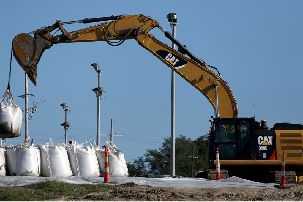 Sand bags are placed on top of a levee as New Orleans prepares for Hurricane Nate. Photo: AFP