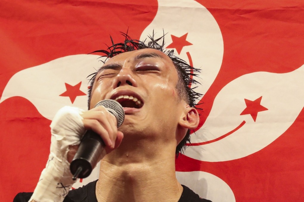 A hurt and tearful Rex Tso talks to the crowd moments after he won his fight against Kohei Kono. Photo: Edward Wong