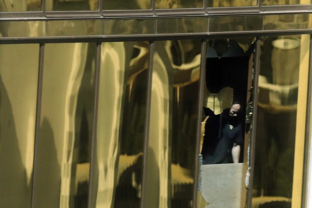 An investigator works in the gunman’s room at the Mandalay Bay Resort and Casino. Photo: AP