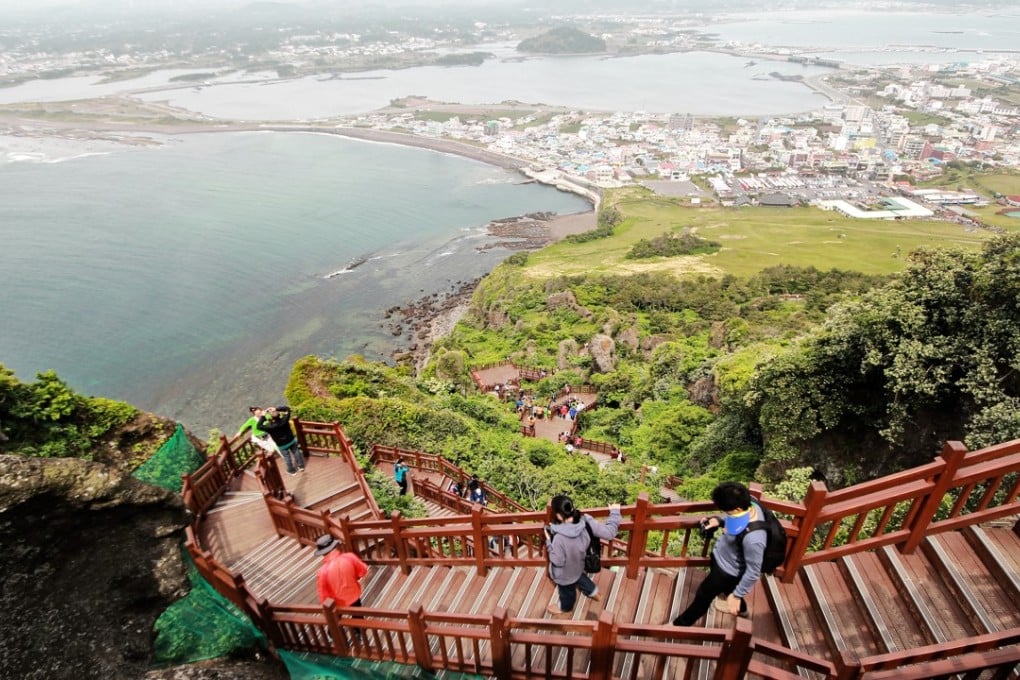 A few Chinese tourists walk along a parth on Jeju Island in South Korea. Handout Photo