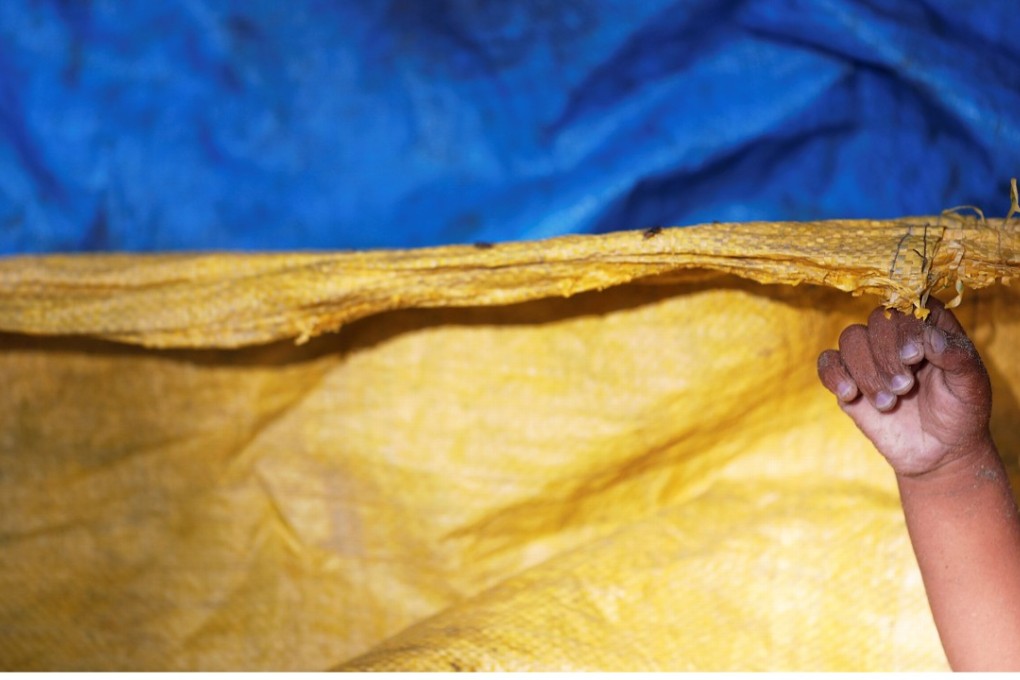 A hand of one of Rohingya refugee children from Myanmar who were killed when their boat capsized on the way to Bangladesh, is seen under the plastic sheeting used to cover bodies of victims brought to a local Islamic school in Shah Porir Dwip, in Teknaf, near Cox's Bazar in Bangladesh. Photo: Reuters