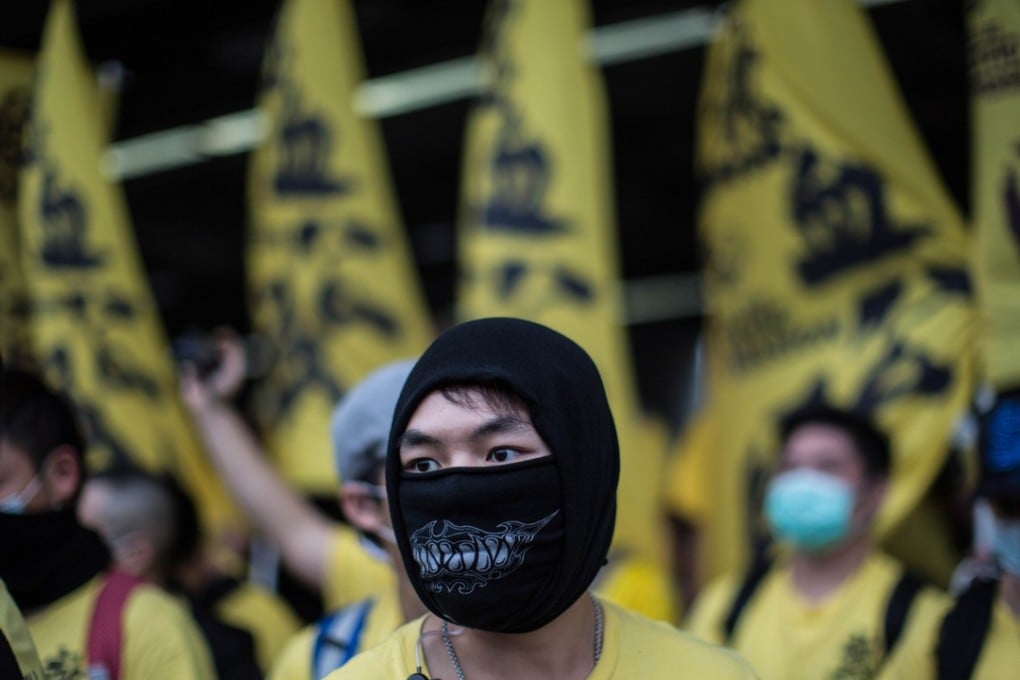 A member of the Civic Passion group looks on as he and other members attend an anti-parallel-trading protest in Yuen Long, Hong Kong, in March 2015. Photo: AFP