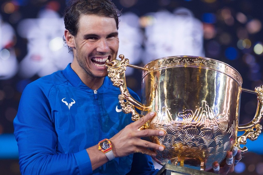 Spain’s Rafael Nadal holds the trophy after winning the China Open against Nick Kyrgios of Australia in Beijing. Photo: AFP