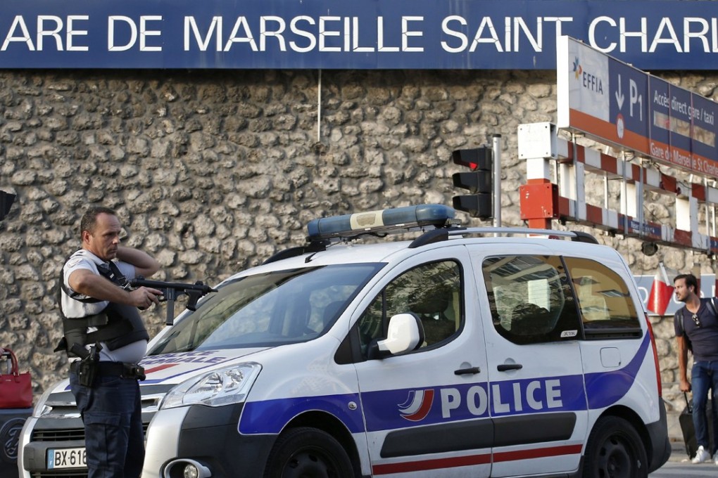 French police officers guard a train station in Marseille where a man armed with a knife killed two women on October 1. Photo: EPA