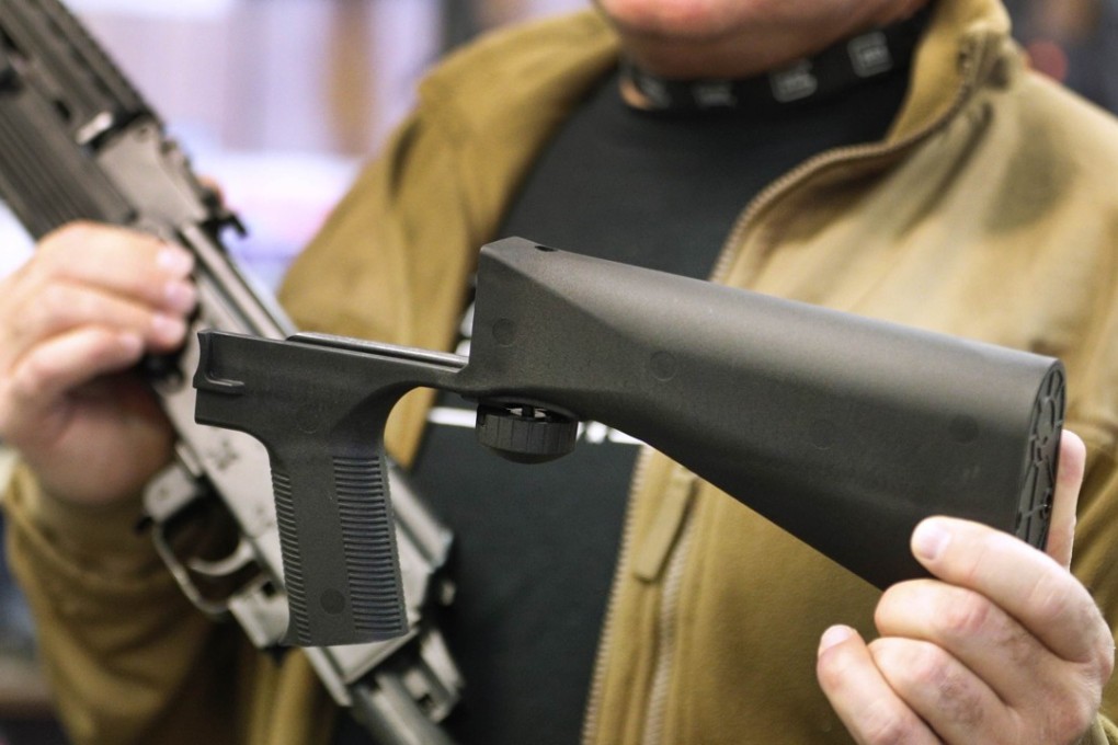 A bump stock device (right), that fits on a semi-automatic rifle to increase the firing speed, making it similar to a fully automatic rifle, is shown next to a AK-47 semi-automatic rifle at a gun store in Salt Lake City, Utah.Photo: AFP