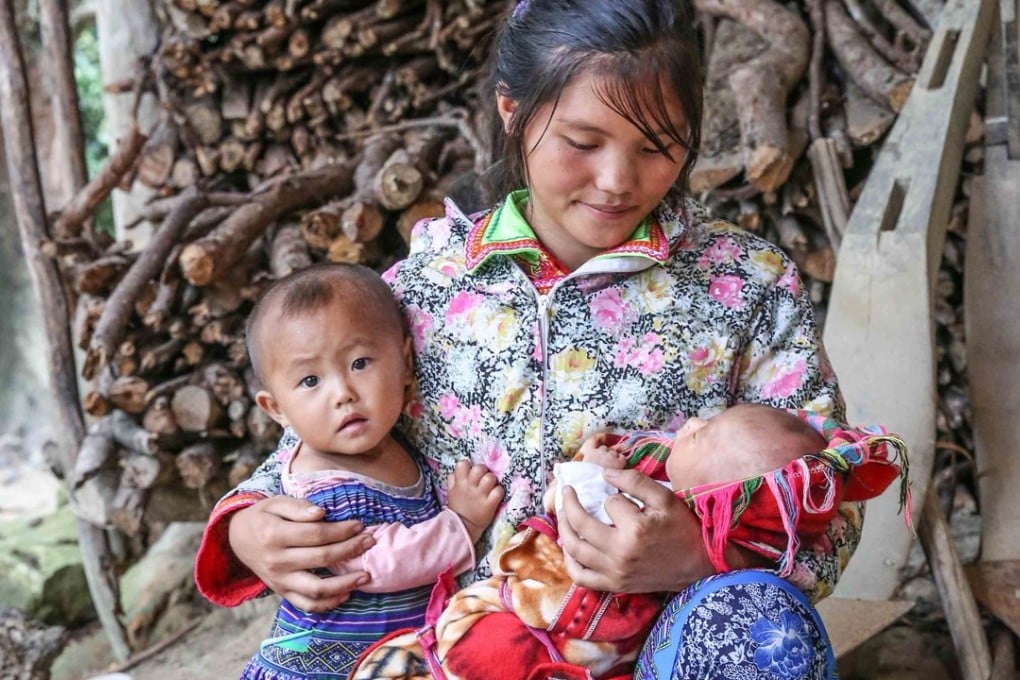 Bang, 16, with her two young children, in Ha Giang, Vietnam. The school dropout spends her days taking care of the family, as a lack of education prevents her from finding a way out of poverty. Photo: Yuki Chang/Plan International Hong Kong