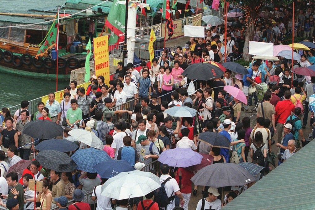 Thousands of visitors queue for a ferry trip back home after the annual Bun Festival parade in Cheung Chau on May 19, 2002. More than 18,000 local residents and foreign tourists flocked to the island for the three-hour parade of traditional floats, lion and unicorn dances and also Chinese folk performances. The Bun Festival, celebrated since 1894, is held to present offerings to safeguard the island and its people. Photo: SCMP