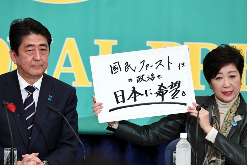 Prime Minister and Liberal Democratic Party leader Shinzo Abe is seen with the head of Japan's Party of Hope, Tokyo governor Yuriko Koike, during a debate on Sunday. Koike’s placard reads “Injecting hope into Japan”. Photo: EPA-EFE