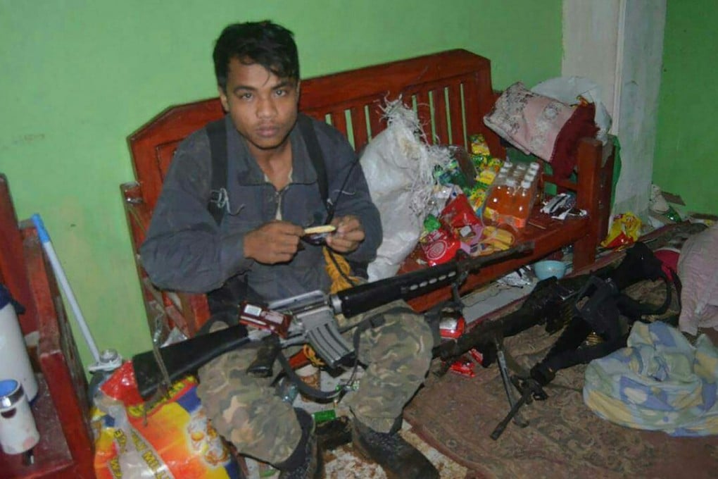 A member of the Maute militant group, which is said to be affiliated with Islamic State, inside a house in Marawi. Photo: AFP