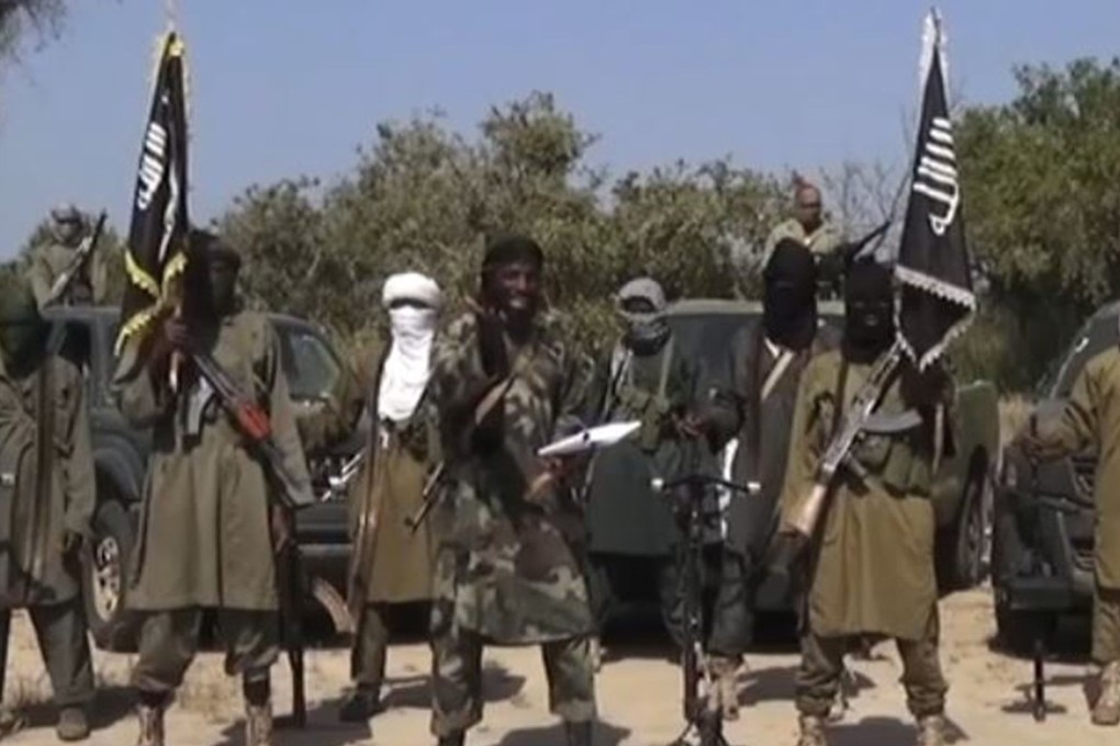 An image grabfrom a 2014 video shows the leader of the Nigerian Islamist extremist group Boko Haram Abubakar Shekau (centre) delivering a speech. Photo: AFP