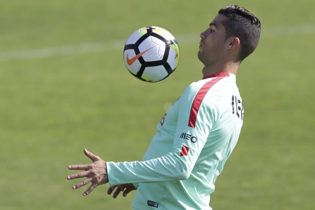 Portugal's Cristiano Ronaldo plays with a ball during a training session in Oeiras, outside Lisbon. He headlines the list of players for the Ballon d’Or, or footballer of the year, award. Photo: AP