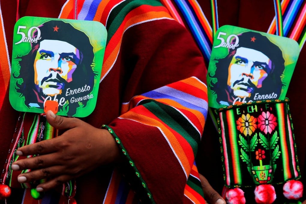 Aymara men hold images of Ernesto Che Guevara as they attend a ceremony to commemorate the 50th anniversary of Che Guevara's death in Vallegrande, Bolivia, on Monday. Photo: Reuters
