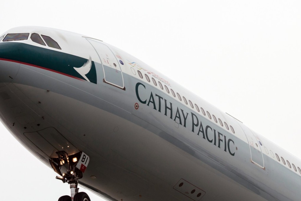 A Cathay Pacific aircraft flies near Hong Kong International Airport in Hong Kong. Photo: Bloomberg