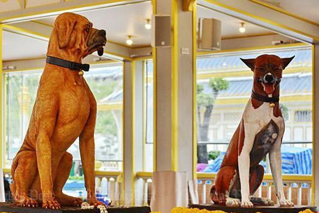 The statues of Khun Jocho, with a smoking pipe in his mouth, and Khun Tongdaeng, the late King's favourite, at the royal crematorium. Photo: Pichaya Svast