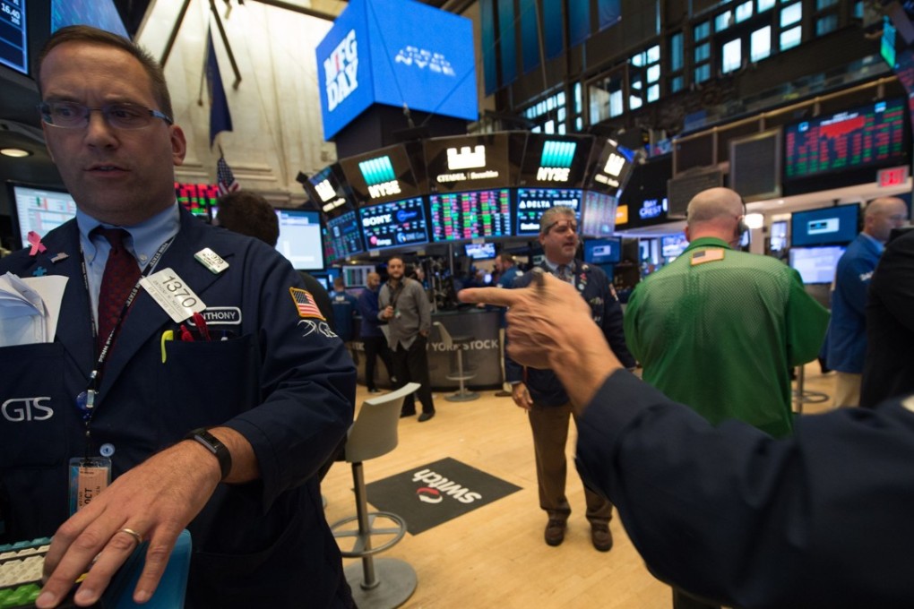 Traders at the New York Stock Exchange as Wall Street posted gains, partly in relief that Catalan’s leaders stopped short of pushing ahead with an independence drive for talks with the government in Spain. Photo: AFP