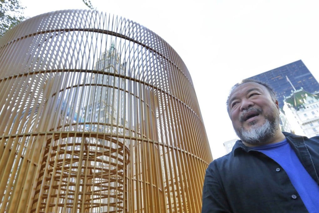 Chinese activist and artist Ai Weiwei poses beside “Gilded Cage”, one of the many works included in his “Good Fences Make Good Neighbours” exhibition in New York. Photo: AP