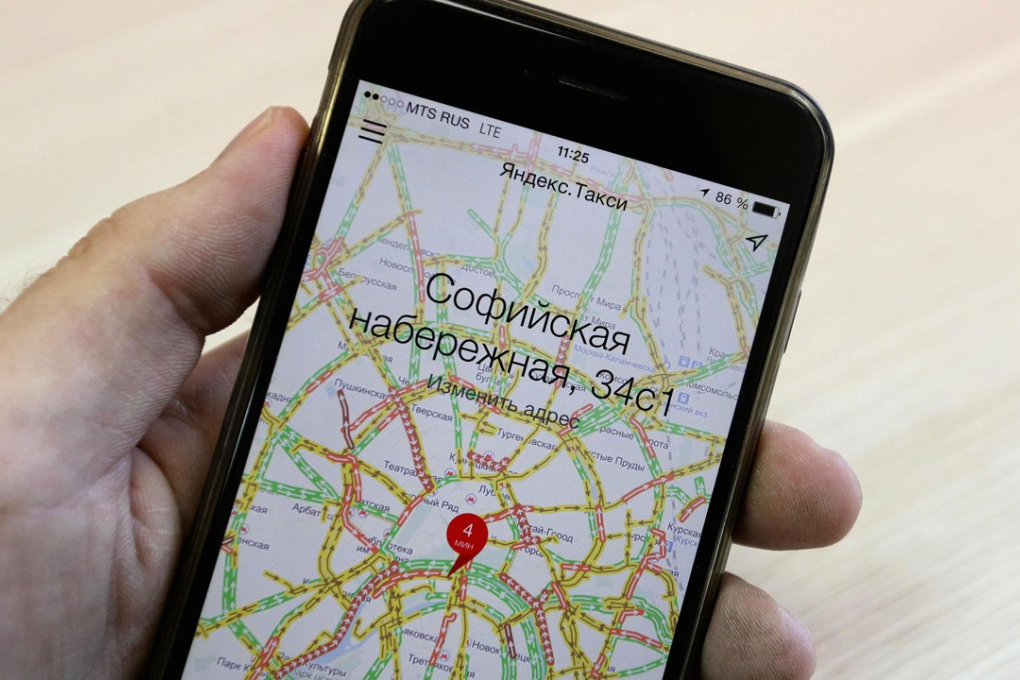 A customer uses the Yandex.Taxi online app on a smartphone to scan for available taxi cabs in Moscow, Russia. Photo: Andrey Rudakov/Bloomberg