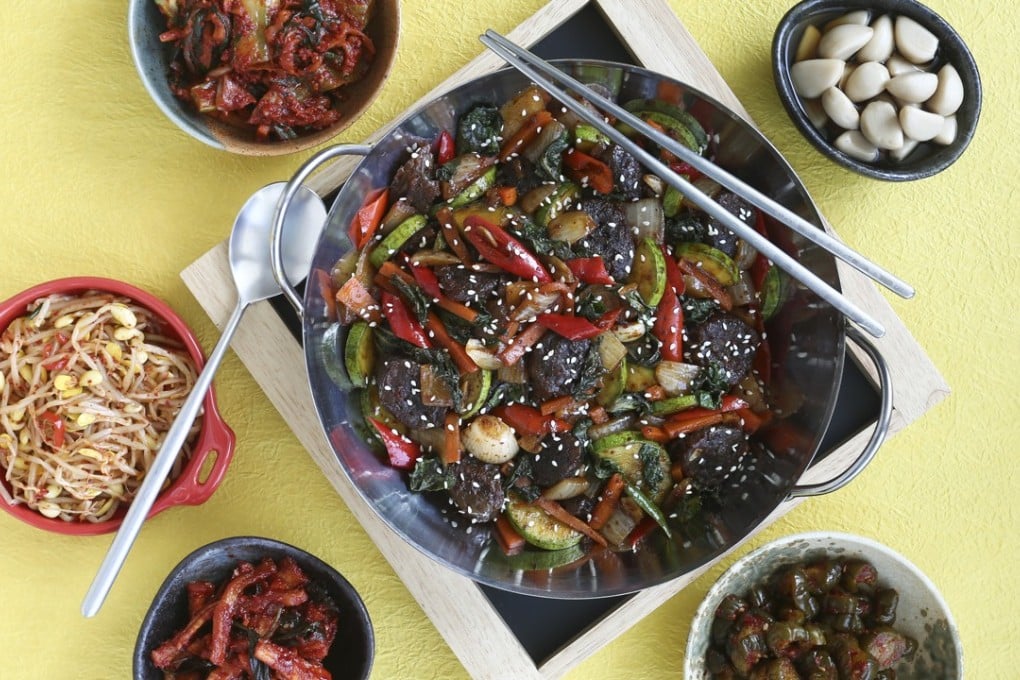 Soondae bokeum served with banchan. Photography: Jonathan Wong. Styling: Nellie Ming Lee