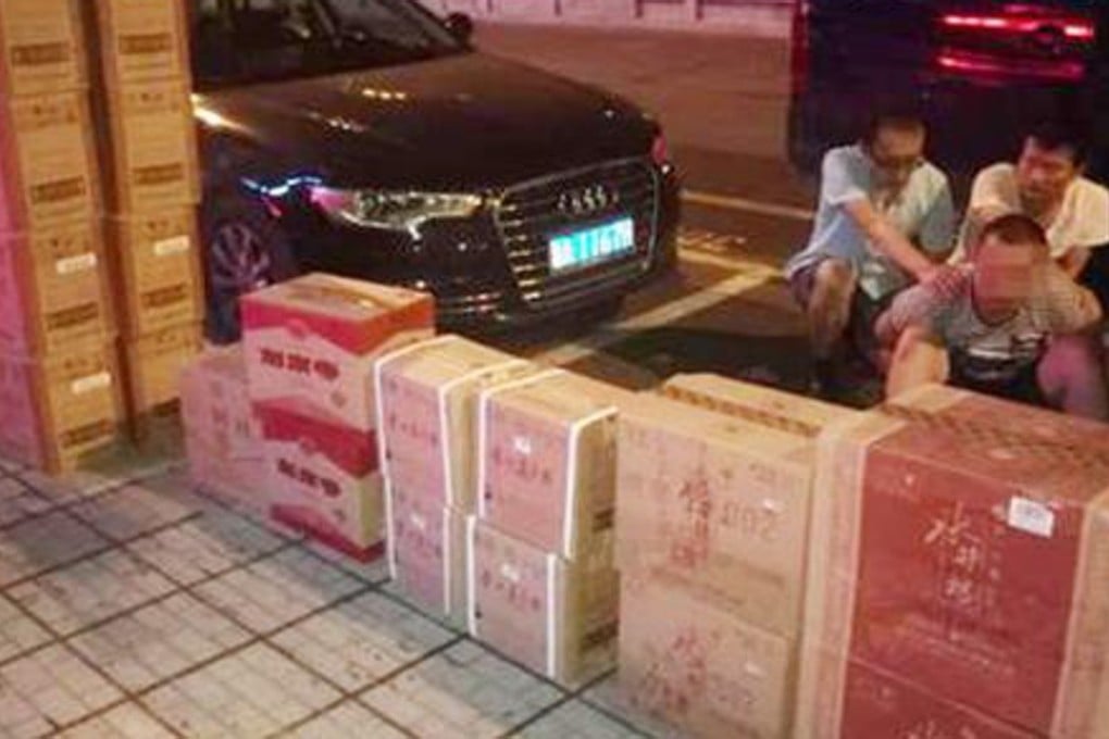 A suspected member of a gang selling counterfeit liquor is detained following a raid on a shop in Zhuzhou, central China’s Hunan province, last month. Police seized 2,000 bottles of fake spirits with a retail value of about US$152,000. Photo: Thepaper.cn