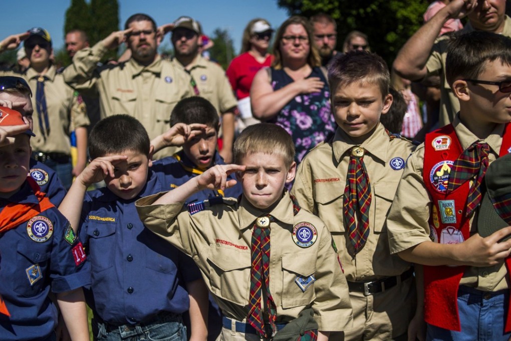 Boy Scouts and Cub Scouts salute during a Memorial Day ceremony in Linden, Michigan, in May. Photo: AP