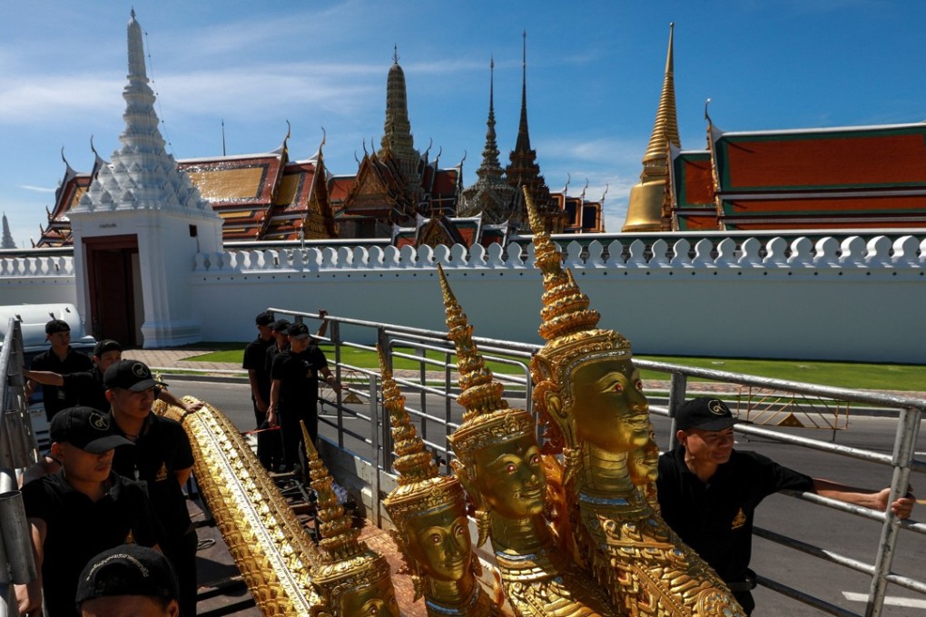 Workers move deity sculptures which will be used during the late king’s funeral. Photo: Reuters