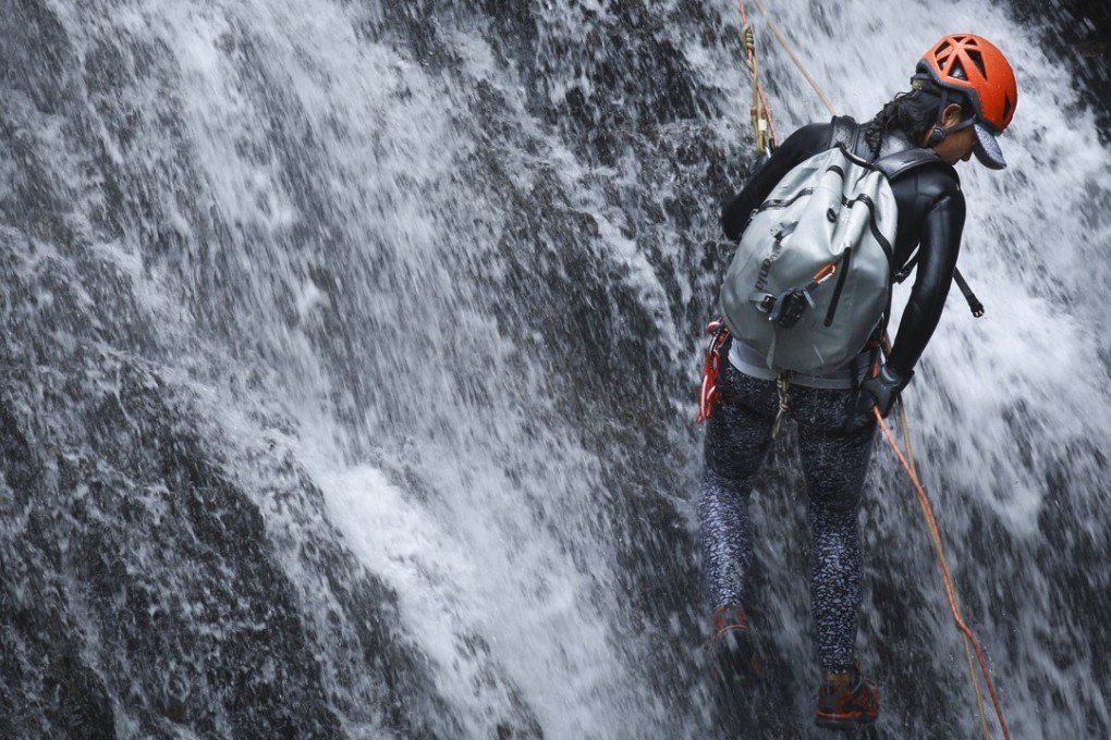 France Huot abseils down a waterfall in the New Territories as part of a day out canyoning with friends. Photo: James Wendlinger