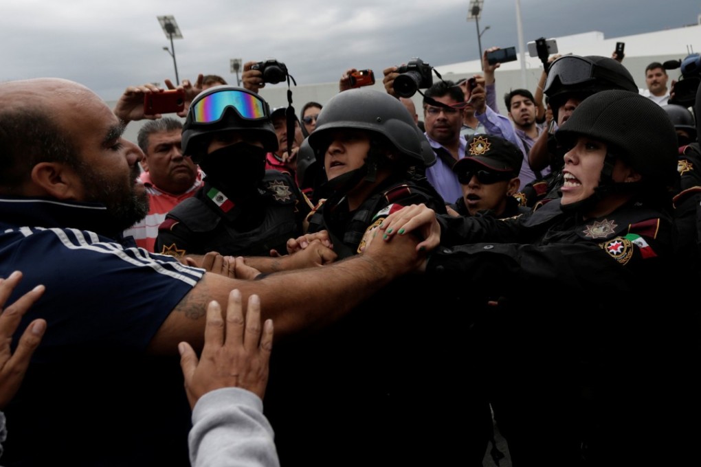Police scuffle with relatives of inmates blocking the main access to Cadereyta state prison after a riot broke out at the prison, in Cadereyta Jimenez, on the outskirts of Monterrey, Mexico, on Tuesday. Photo: Reuters