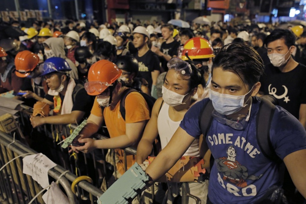 Protesters guard makeshift barricades at a pro-democracy protest encampment in the Mong Kok district of Hong Kong in October 2014. Photo: AP