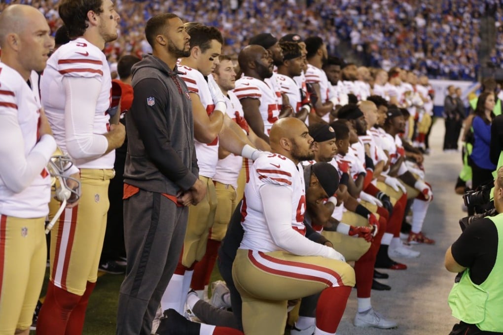 Members of the San Francisco 49ers kneel during the playing of the national anthem. Photo: AP