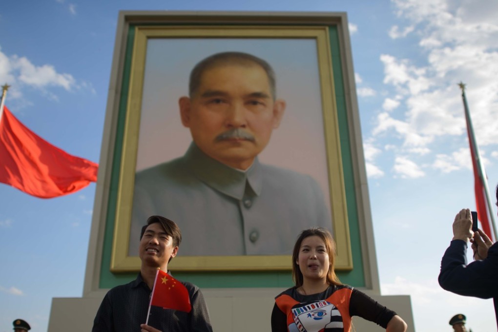 Tourists pose in front of a portrait of Sun Yat-sen in Tiananmen Square, Beijing, on October 1, 2013, on the anniversary of the founding of the People’s Republic of China. Photo: AFP