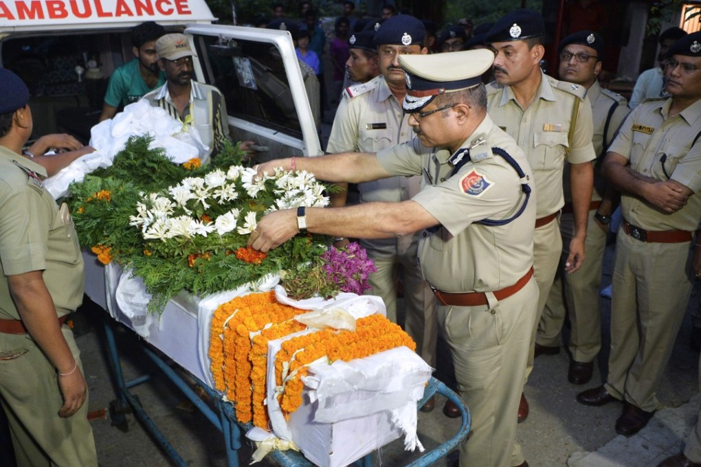 Indian police pay their respects to an officer who was killed during a gunfight between West Bengal authorities and suspected Gorkha Janamukti Morcha supporters in Darjeeling. Photo: AFP