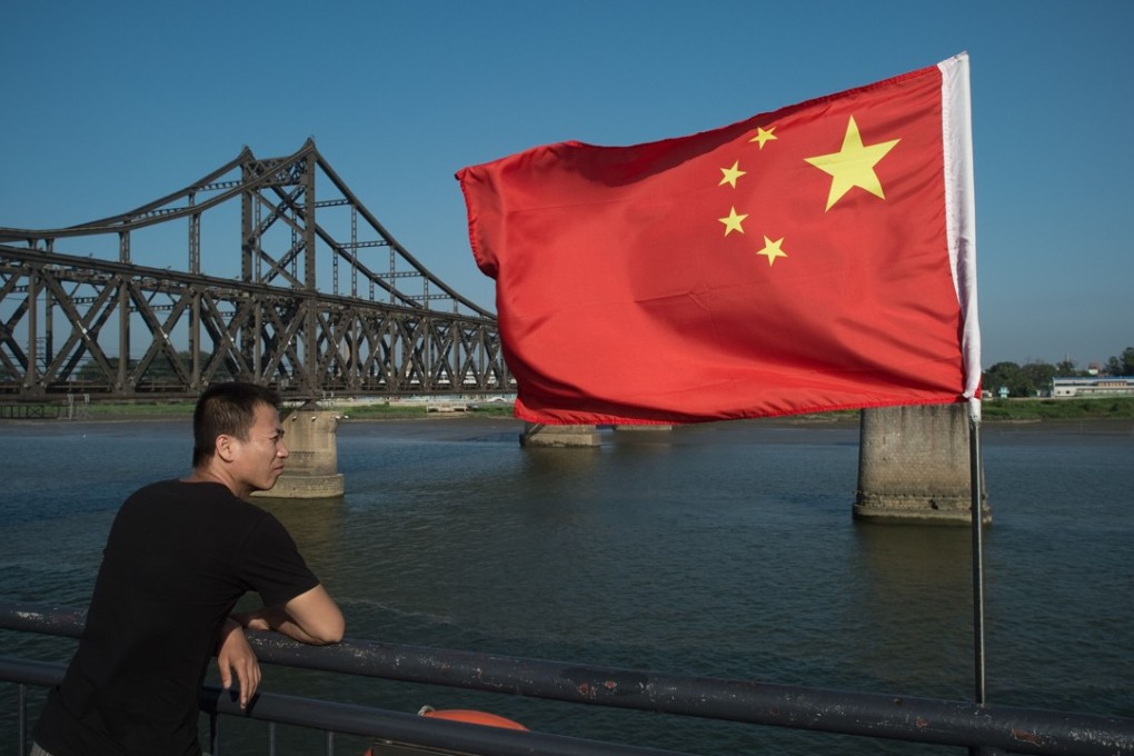 A man stands near the Friendship Bridge on the North Korean-Chinese border. China’s trade with its restive neighbour slumped in September amid UN sanctions aimed at deterring Kim Jong-un from pursuing his nuclear weapons and missiles programmes. Photo: AFP