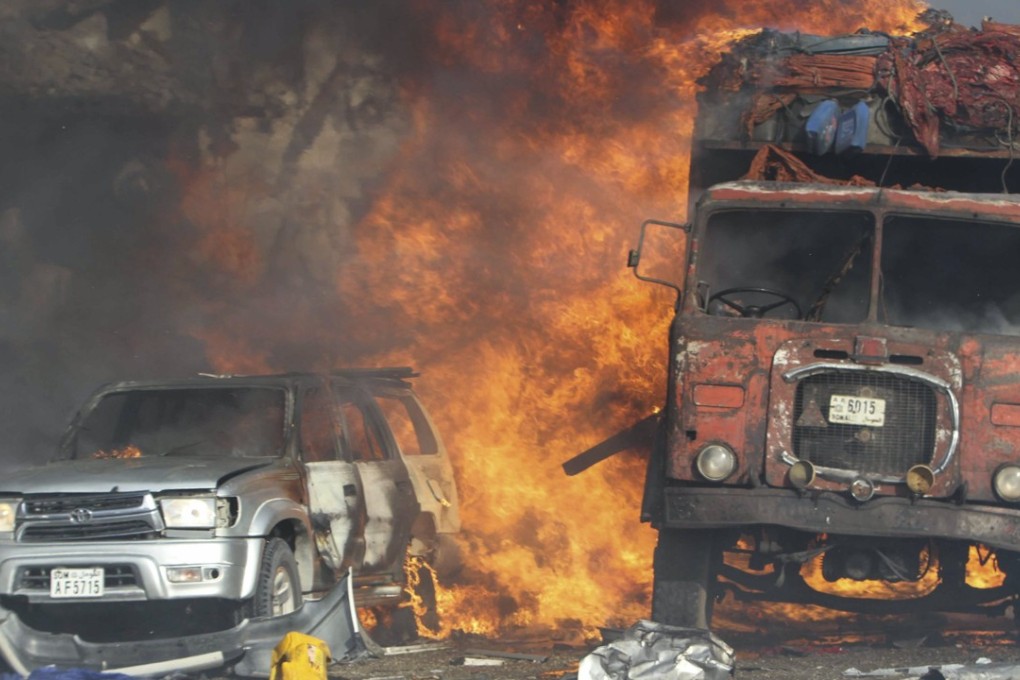 Vehicles burn at the scene of a massive explosion in front of the Safari Hotel in Mogadishu, Somalia. Photo: EPA