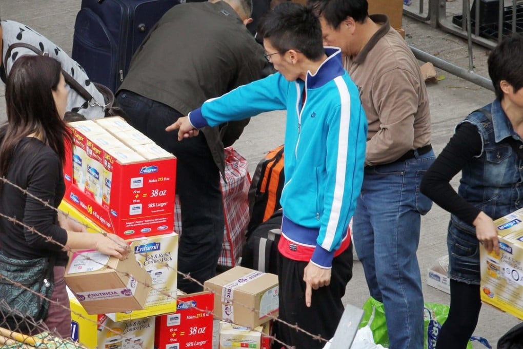 Traders handling luggage outside Sheung Shui station in 2013. Photo: Nora Tam