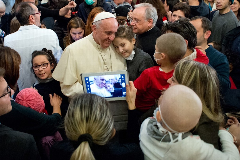 Pope Francis poses with children during a visit to the Bambino Gesu Paediatric Hospital. Photo: AP