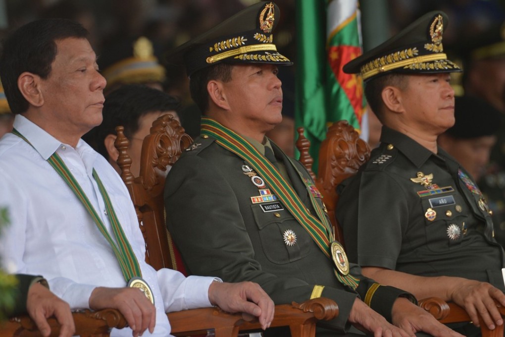 Philippine President Rodrigo Duterte sitting next to new army commanding general Major General Rolando Bautista (centre) and military chief General Eduardo Ano during the turnover ceremony of the army commanding general at Fort Bonifacio in Manila. Photo: AFP