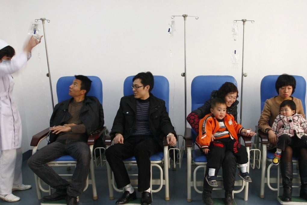 A nurse adjusts intravenous drips for patients of all ages, at a hospital in Suining in Sichuan province. Photo: Reuters