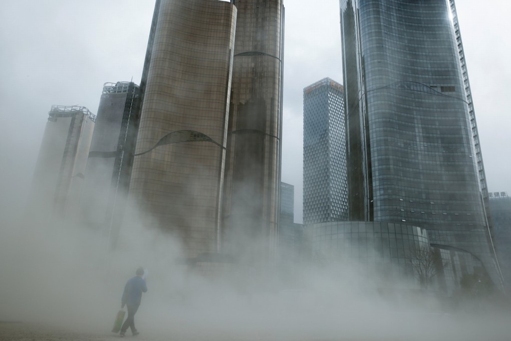 A man walks through a cloud of dust whipped up by wind at the construction site near new skyscrapers in Beijing, where a company leasing a 30,000 sq ft grade A office needs to invest US$19,095,807, or US$637 per square foot, over five years. Photo: Reuters