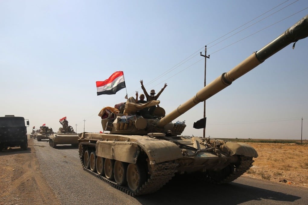 Iraqi forces drive towards Kurdish peshmerga positions on October 15, 2017, on the southern outskirts of Kirkuk. The presidents of Iraq and Iraqi Kurdistan held talks to defuse an escalating crisis, after a deadline for Kurdish forces to withdraw from disputed positions was extended by 24 hours. Photo: AFP