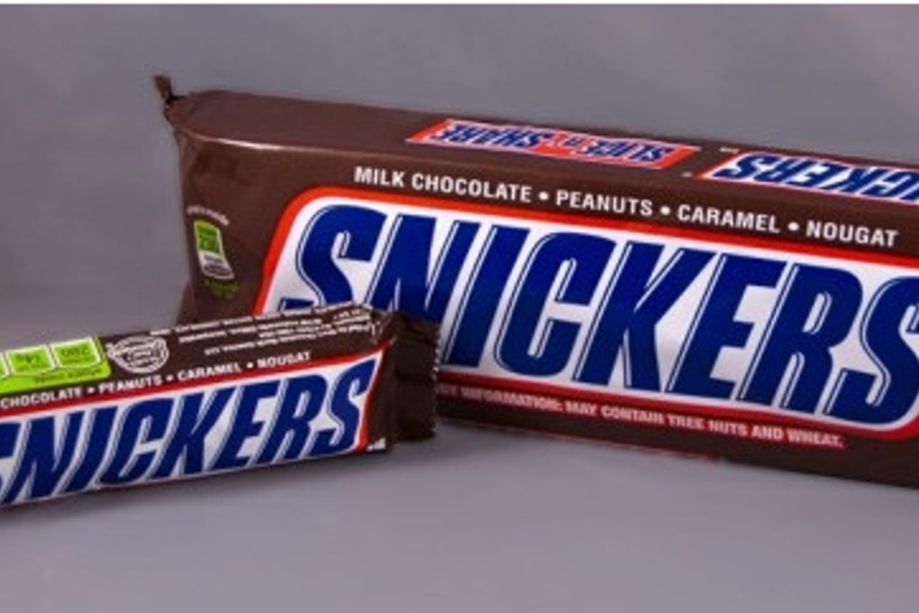 A 450 gram Snickers Slice 'n' Share chocolate bar (right) alongside a regular Snickers. Photo: Mars Inc