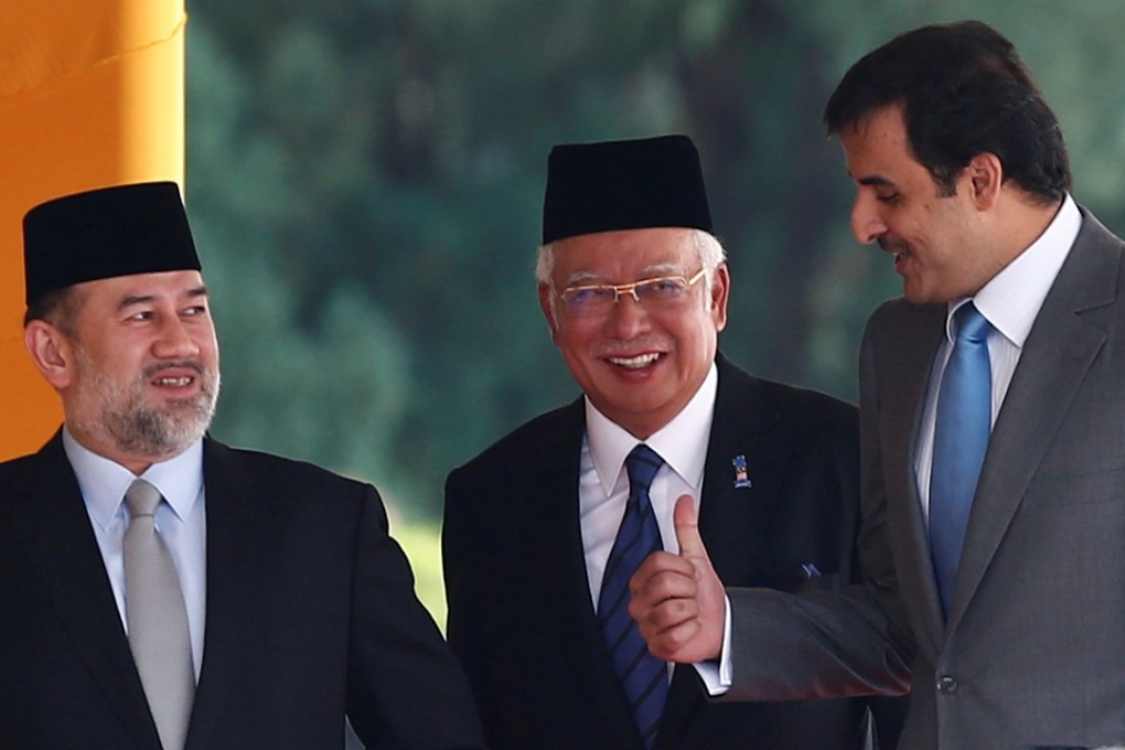 Qatar’s Emir Sheikh Tamim (right) speaks with Malaysia’s Prime Minister Najib Razak (centre) and King Muhammad V after a state welcoming ceremony at Parliament House in Kuala Lumpur. Photo: Reuters