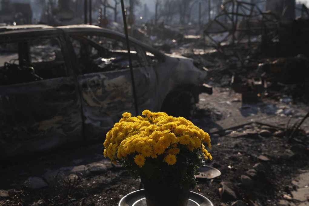 Fresh flowers are placed on Sunday, October 15, 2017, in the Coffey Park neighbourhood in Santa Rosa, California, that was devastated by the deadliest fire in the state’s history. Photo: AP