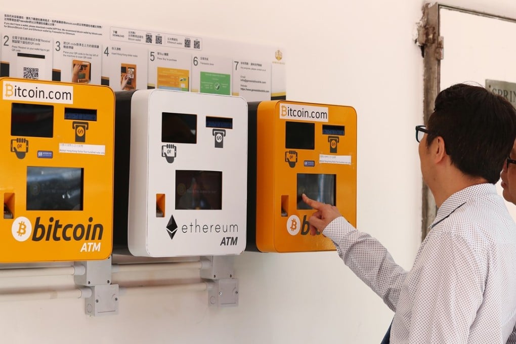 Passers-by look at bitcoin ATMs at the Genesis Block co-working space in Wan Chai. Photo: Nora Tam