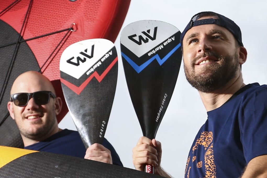 Tim Tait (L) and Johnny Haines prepare to paddle board around Lantau for plastic pollution. Photo: Xiaomei Chen