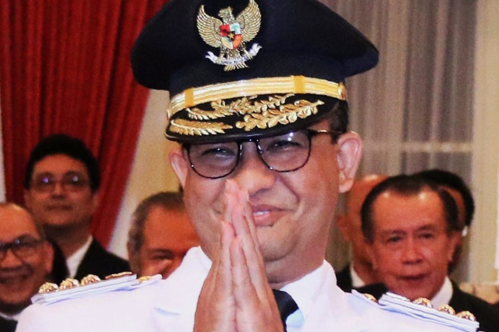 Anies Baswedan greets supporters during his inauguration at the Indonesian Presidential Palace in Jakarta. Photo: AFP