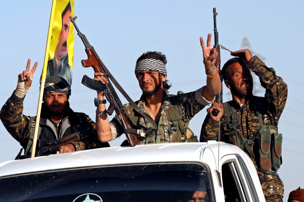US-backed fighters celebrate in the streets after clearing Islamic ...