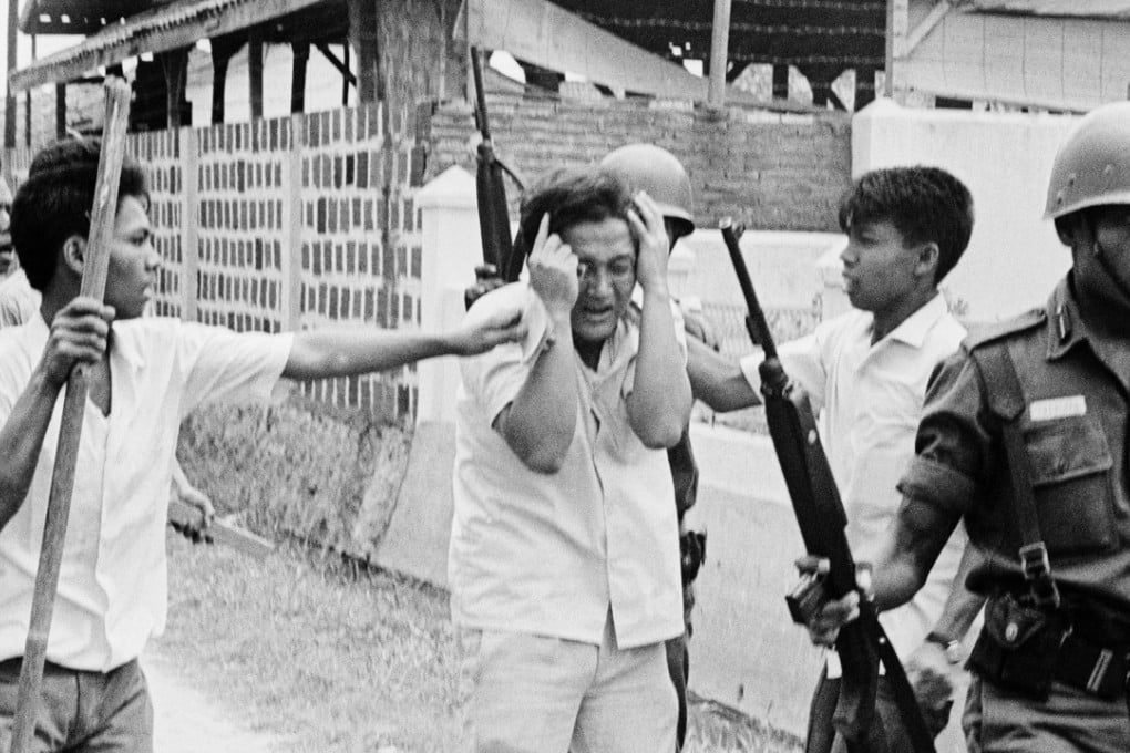 A Chinese student protects himself as he is assaulted by Indonesian youths in 1965. File photo: Corbis