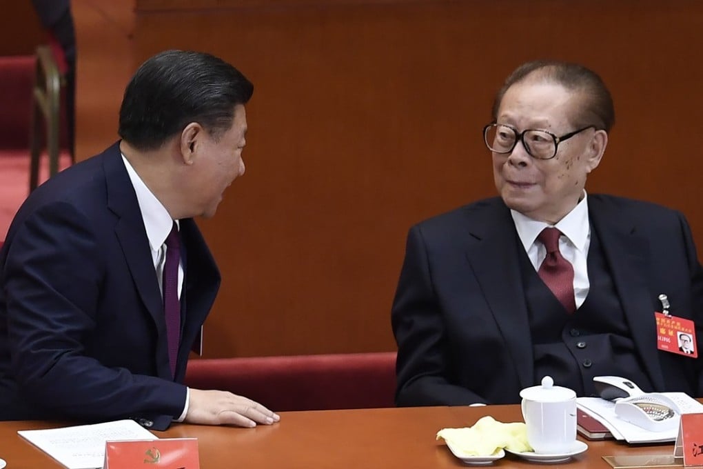 Chinese President Xi Jinping (left) chats to former President Jiang Zemin at the opening session of the 19th national congress in Beijing. Photo: AFP